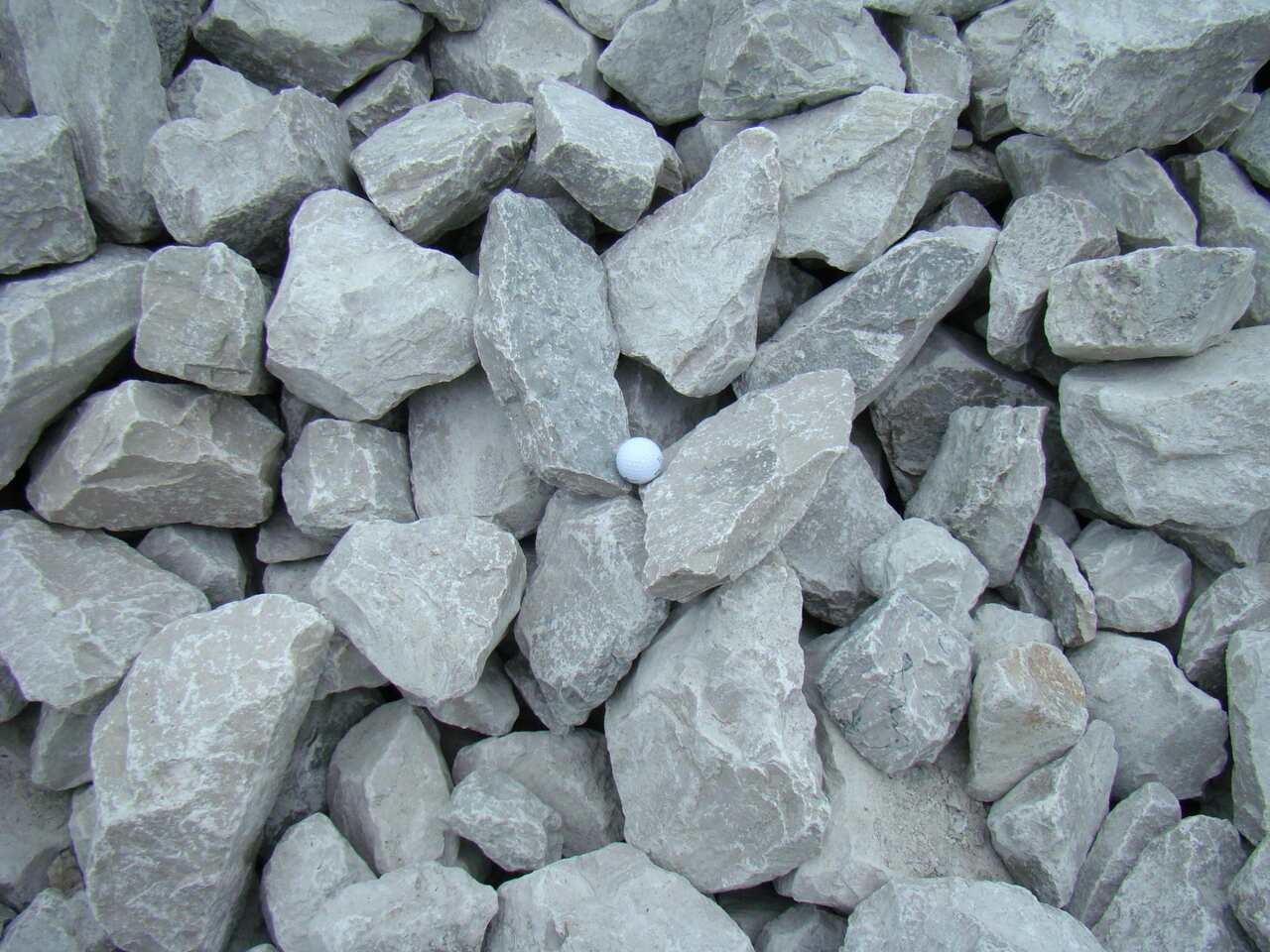 Close-up of grey limestone rip rap stacked in a pile